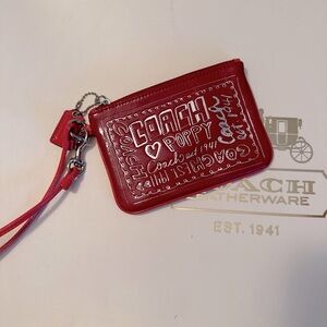 Red Coach women's patent leather wristlet from Coach Poppy collection